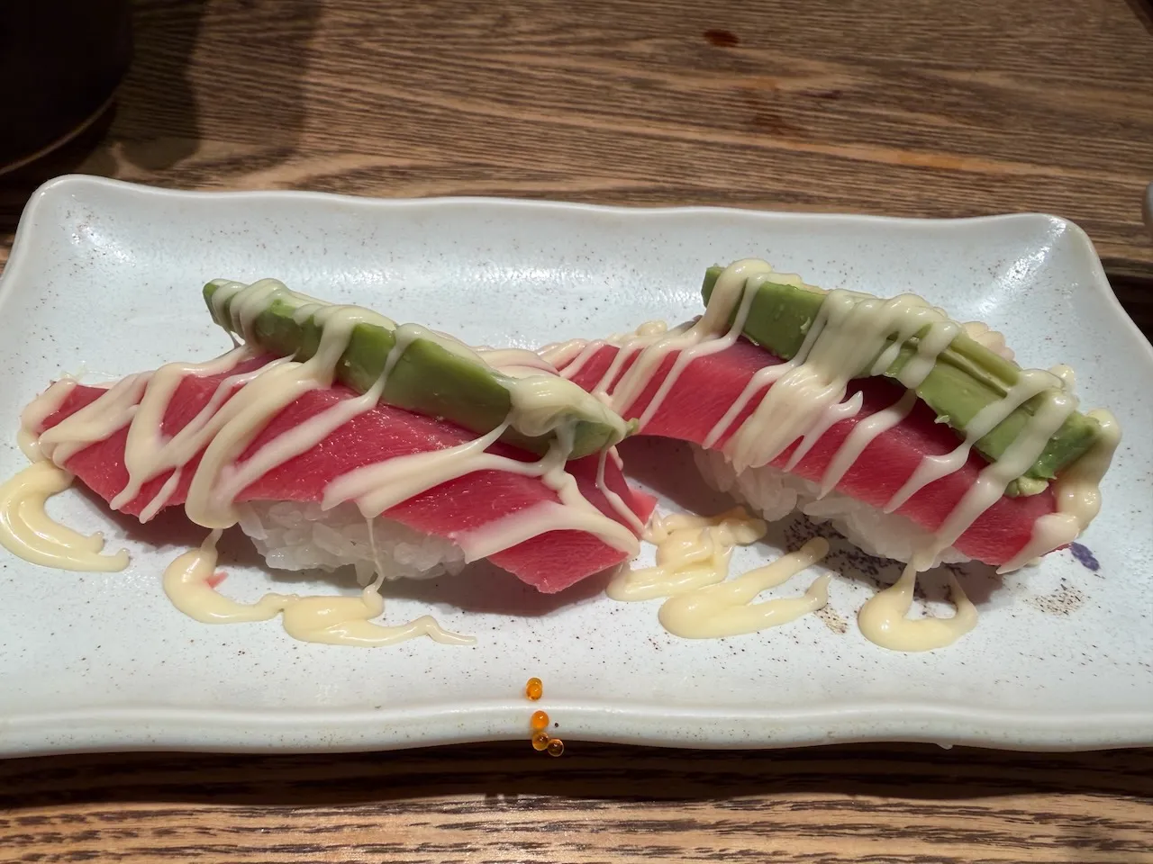 Seared salmon nigiri with mayo on a plate, Osaka