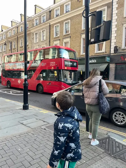 Red double-decker bus street scene, London, our trip 2024