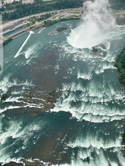 helicopter view of Horseshoe Falls, Toronto and Niagara Falls, our trip 2024